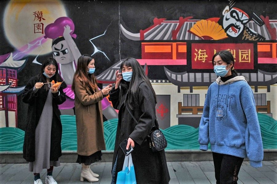 Women visit a tourist area in Shanghai on 8 March 2021. (Hector Retamal/AFP)