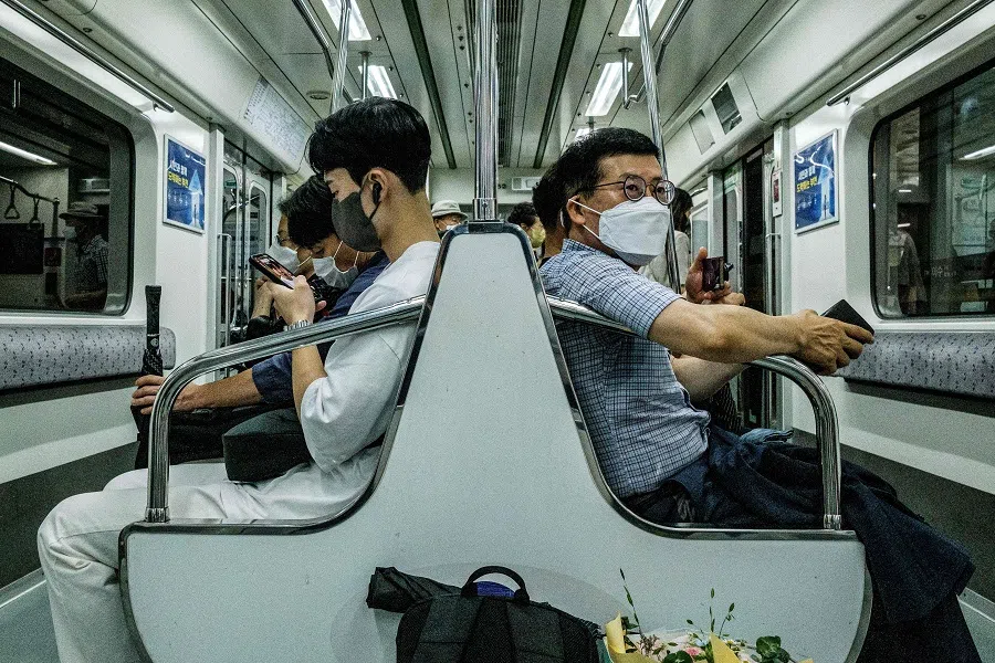 Commuters ride an underground metro train in Seoul, South Korea, on 30 June 2022. (Anthony Wallace/AFP)