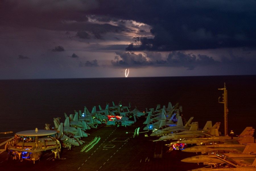 Lightning flashes over the US Navy aircraft carrier USS Nimitz as it transits the South China Sea, 4 July 2020. (US Navy/Mass Communication Specialist 1st Class John Philip Wagner, Jr./Handout via REUTERS)
