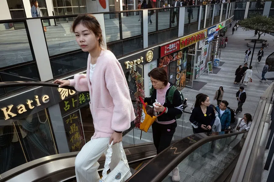 Pedestrians in the Sanlituan area of Beijing, China, on 28 October 2023. (Bloomberg)
