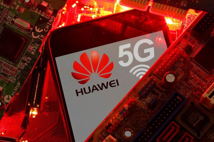 A smartphone with the Huawei and 5G network logo is seen on a PC motherboard in this illustration picture, 29 January 2020. (Dado Ruvic/REUTERS)