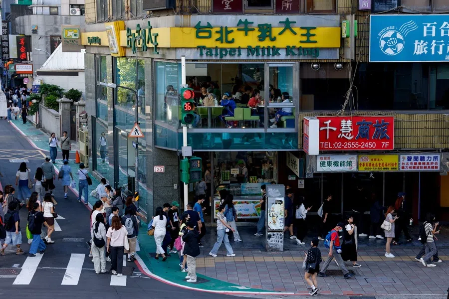 People walk in a shopping district in Taipei, Taiwan, 8 November 2025. (Ann Wang/Reuters)