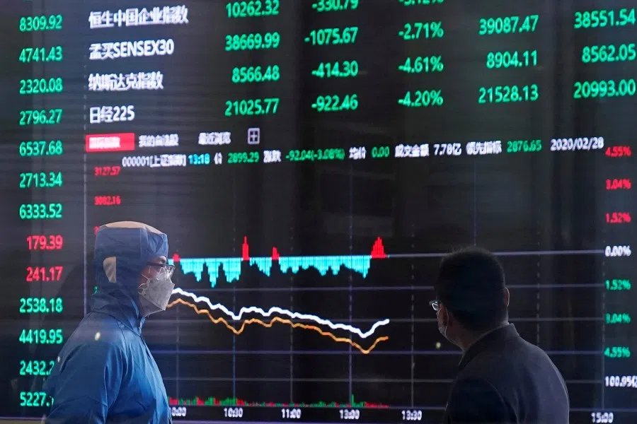 A worker wearing a protective suit is seen inside the Shanghai Stock Exchange building amid the coronavirus outbreak, at the Pudong financial district in Shanghai, February 28, 2020. (Aly Song/REUTERS)