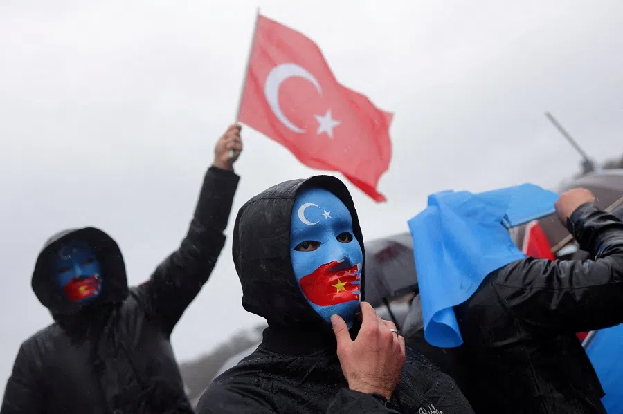 An ethnic Uighur demonstrator waves a Turkish flag during a protest against China, near the Chinese consulate in Istanbul, Turkey, on 5 February 2023. (Murad Sezer/Reuters)