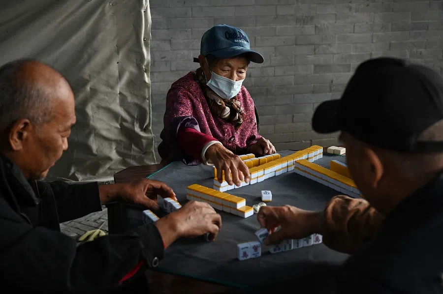 A group of elderly people play mahjong in a small park in Beijing, China, on 3 November 2024. (Greg Baker/AFP)