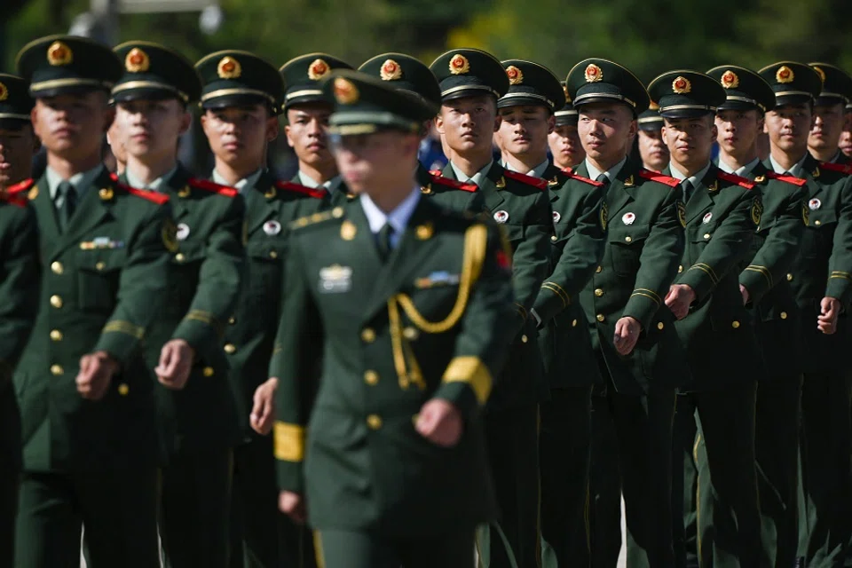 Chinese soldiers march in formation in Beijing's Tiananmen Square on 30 September 2023. (Pedro Pardo/AFP)