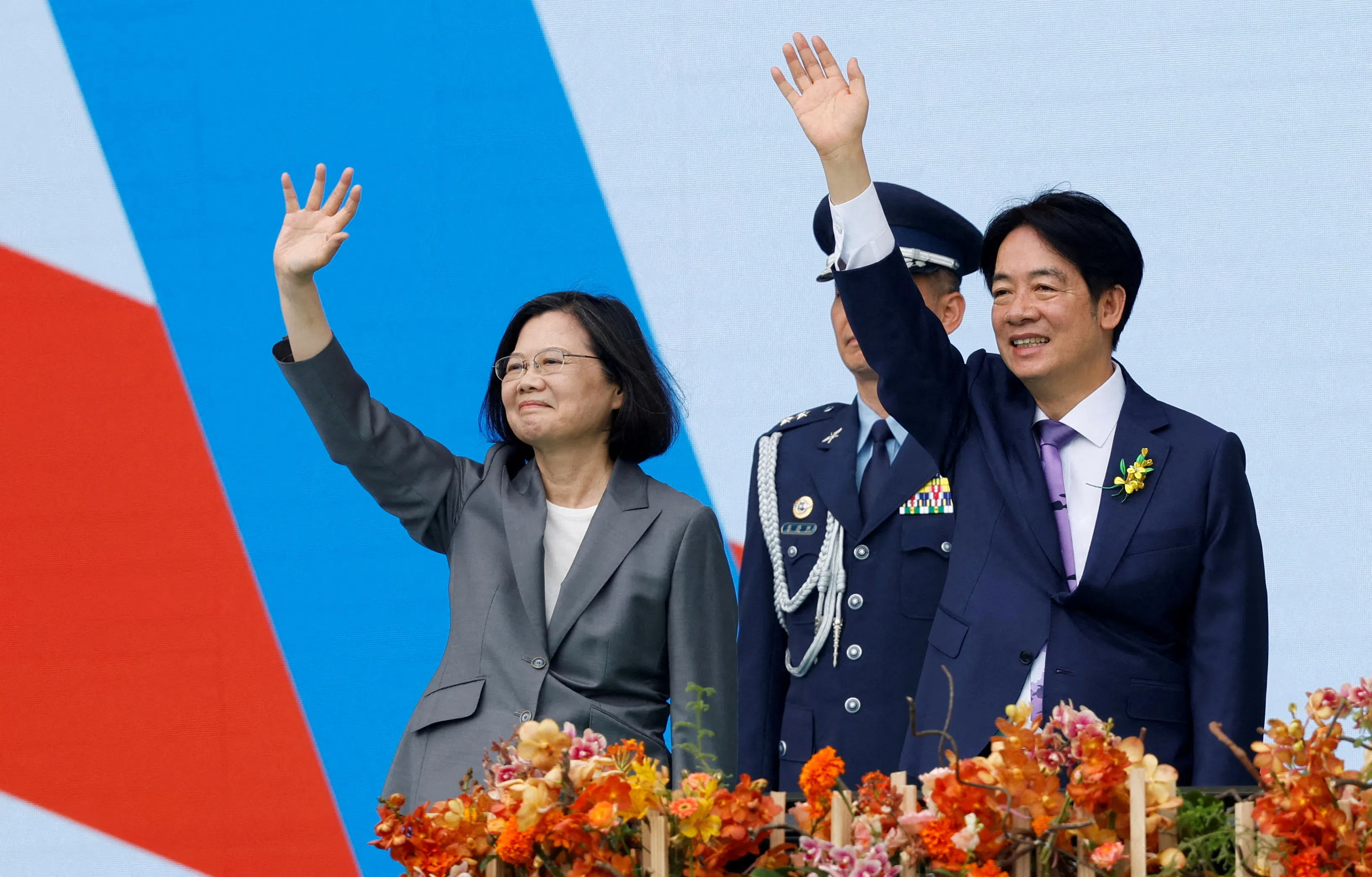 Taiwan’s former President Tsai Ing-wen and new President William Lai wave to people during the inauguration ceremony outside the Presidential office building in Taipei, Taiwan, 20 May 2024. (Carlos Garcia Rawlins/Reuters)