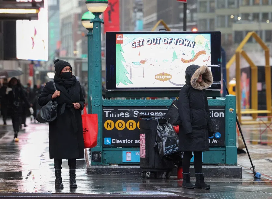 People make their way through Times Square in New York City, US, 28 February 2023. (Caitlin Ochs/Reuters)
