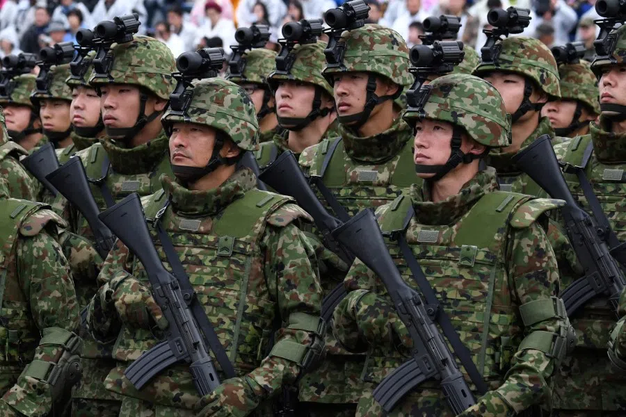 This file photo taken on 14 October 2018 shows soldiers from the Japan Ground Self-Defense Force taking part in a military review at the Ground Self-Defense Force's Asaka training ground in Asaka, Saitama prefecture. Japan announced on 16 December 2022 its biggest defence overhaul in decades, hiking spending, reshaping its military command and acquiring new missiles to tackle the threat from China. (Kazuhiro Nogi/AFP)