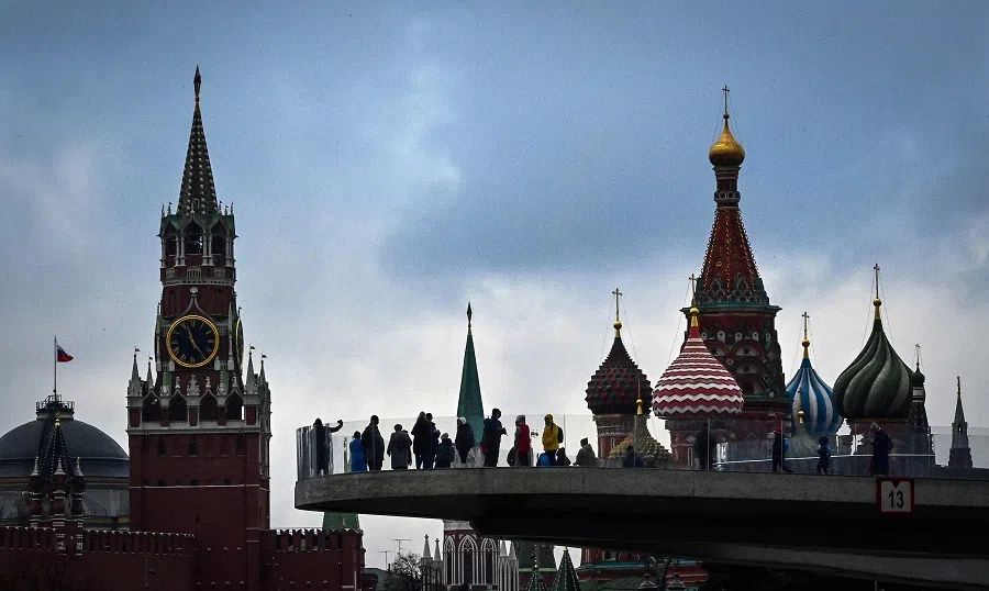 This file photograph taken on 4 November 2021 shows pedestrians as they walk on a bridge in the Zaryadye Park in central Moscow, Russia. (AFP)