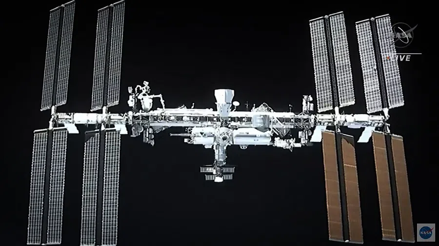 This screen grab taken from the NASA live feed shows the International Space Station taken from the SpaceX's Crew Dragon spacecraft before docking on 24 April 2021. (NASA/AFP)