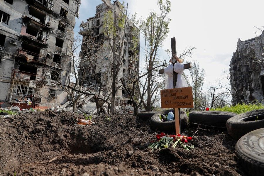 The grave of a civilian killed during the Ukraine-Russia conflict in the southern port city of Mariupol, Ukraine, 3 May 2022. A grave board reads: "Kolesnikov Anatoly Ivanovich". (Alexander Ermochenko/Reuters)