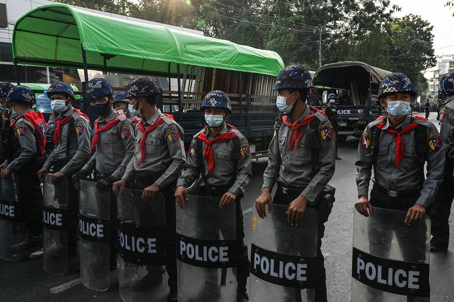Police block the street leading to the headquarters of the National League for Democracy (NLD) in Yangon, Myanmar, on 15 February 2021, after the military seized power in a coup two weeks ago. (Ye Aung Thu/AFP)