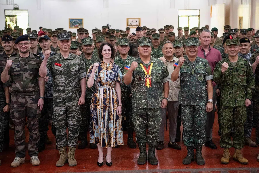 Philippine marines Commandant Major General Arturo Rojas (third from right), Brigadier General Vicente Blanco (second from right) Philippines exercise director, Japanese Major General Toshikatsu Musha (right) Commanding General amphibious rapid deployment brigade, and New Zealand ambassador to the Philippines Catherine McIntosh (third from left) gesture during the opening ceremony of the “Kamandag” annual military exercise between the US and Philippines in Manila on 26 May 2025.  (Ted Aljibe/AFP)