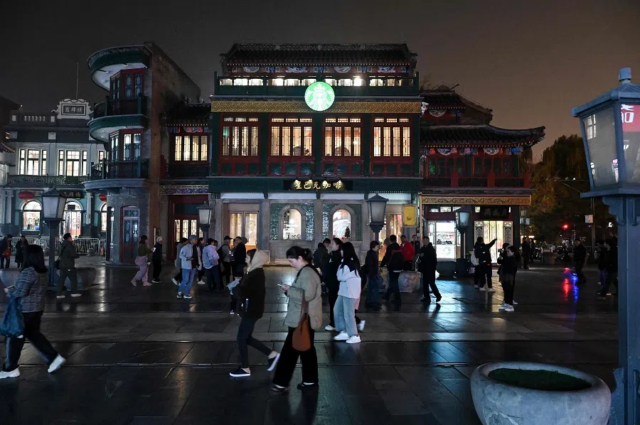 People visit the Qianmen street in Beijing on 15 November 2024. (Adek Berry/AFP)