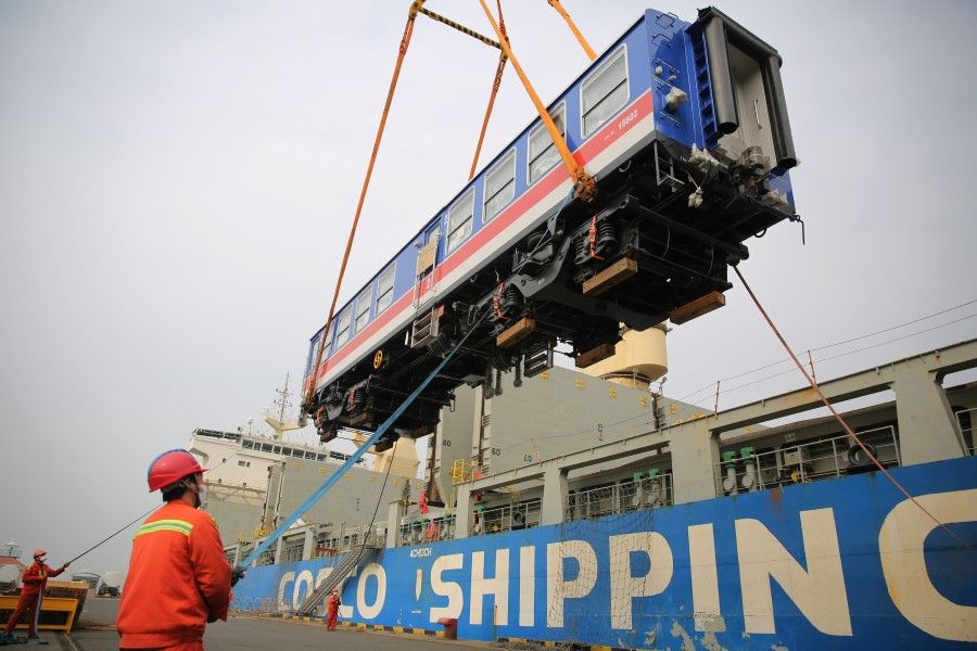 Workers load a carriage of a China Railway High-speed train to be exported to Sri Lanka onto a container ship at a port in Qingdao, March 2020. (REUTERS)