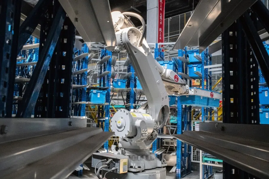 A robotic arm sort books inside a warehouse at the JD.Com Inc. Asia No. 1 Kunshan Logistics Park in Kuchan, Jiangsu province, China, on 8 June 2023. (Bloomberg)