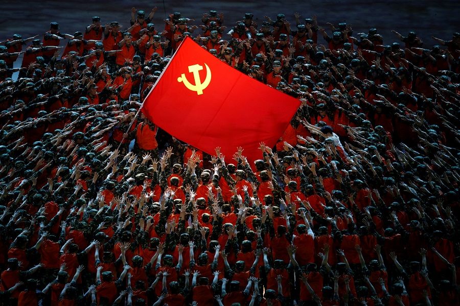 Performers rally around the party's flag during a show commemorating the 100th anniversary of the founding of the Communist Party of China at the National Stadium in Beijing, China, 28 June 2021. (Thomas Peter/Reuters)
