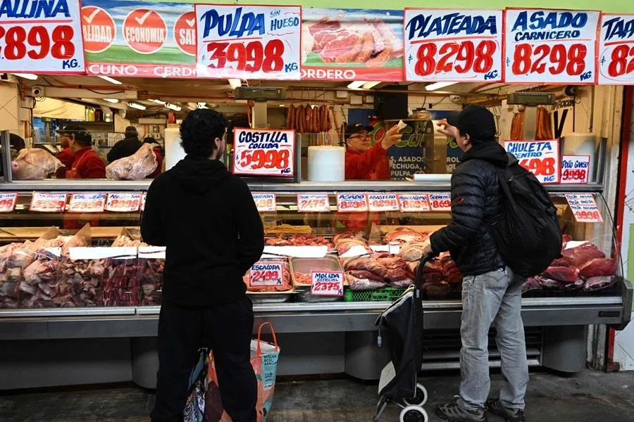 People buy meat at the farmers' market in Santiago on 17 June 2026.