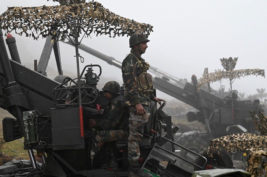 Indian Army soldiers are pictured on a Bofors gun positioned at Penga Teng Tso ahead of Tawang, near the Line of Actual Control (LAC), neighbouring China, in India's Arunachal Pradesh state on 20 October 2021. (Money Sharma/AFP)