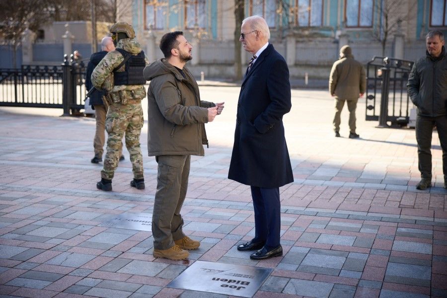 This handout picture taken and released by the Ukrainian Presidential press service on 20 February 2023 shows US President Joe Biden (right) and Ukrainian President Volodymyr Zelenskyy (left) visiting the Walk of the Brave on Constitution Square as part of the unveiling ceremony of a plaque dedicated to the US president following a meeting at Mariinsky Palace in Kyiv. (Handout/Ukrainian Presidential Press Service/AFP)