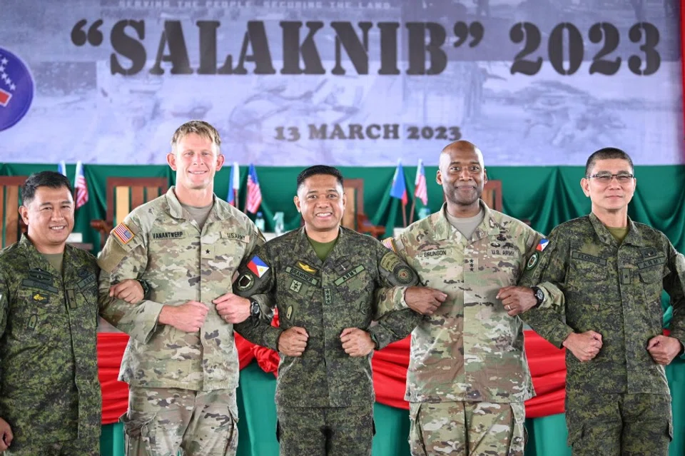 Philippines and US officers link arms during the opening ceremony of US-Philippines Arm-to-Army exercise at Fort Magsaysay, in Nueva Ecija province, north of Manila on 13 March 2023. (Ted Aljibe/AFP)