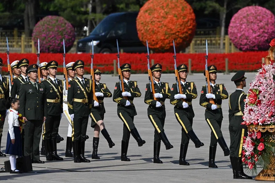 Members of a military honour guard marching in Beijing’s Tiananmen Square on 30 September 2025. (Greg Baker/AFP)