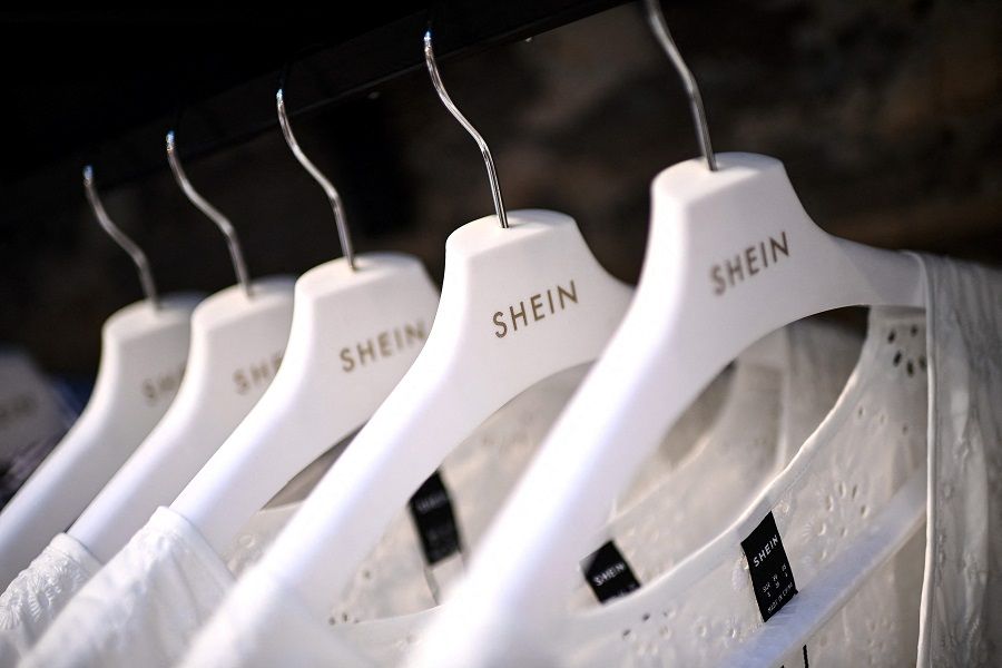 Clothes are displayed on hangers at a Chinese fashion brand Shein pop-up store in Paris, France, on 4 May 2023. (Christophe Archambault/AFP)