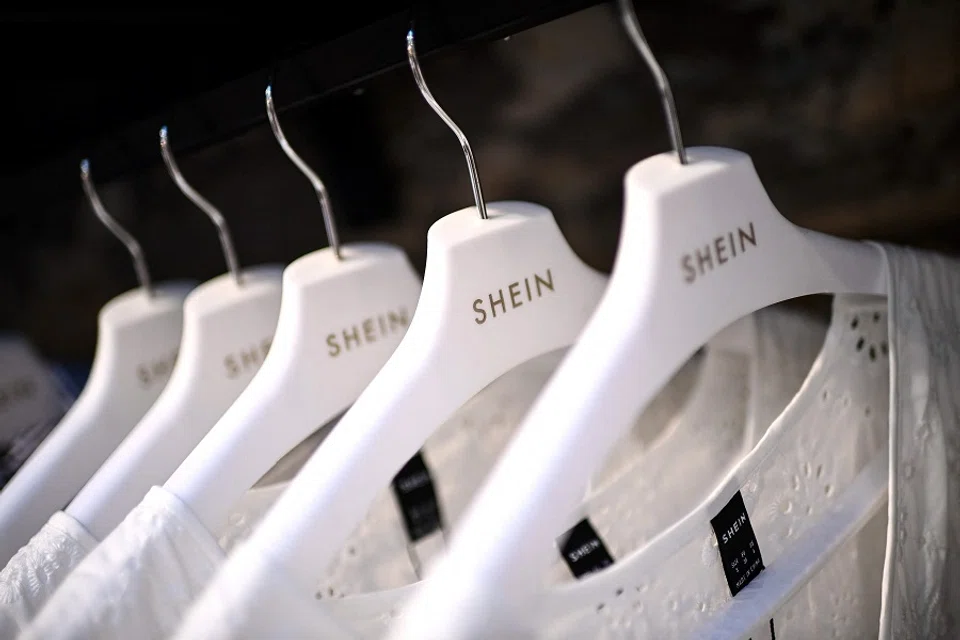 Clothes are displayed on hangers at a Chinese fashion brand Shein pop-up store in Paris, France, on 4 May 2023. (Christophe Archambault/AFP)