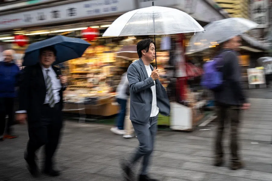 People visit a shopping street in Asakusa district near Sensoji Temple, a popular tourist location in Tokyo, during the last day of “Golden Week” holiday on 6 May 2025. (Philip Fong/AFP)
