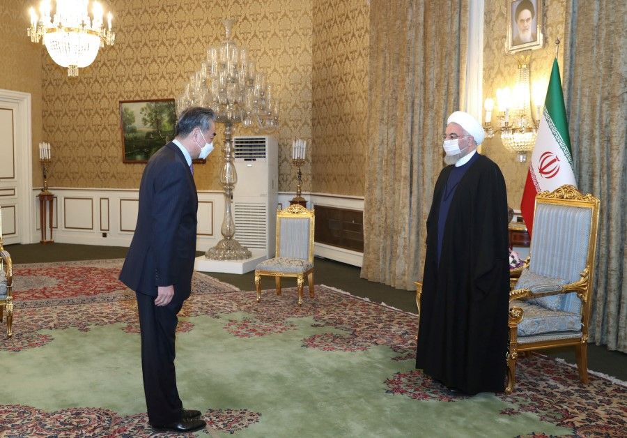 Iranian President Hassan Rouhani meets with Chinese Foreign Minister Wang Yi, in Tehran, Iran, 27 March 2021. (Official Presidential website/Handout via Reuters)