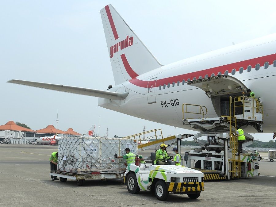 Workers unload a consignment of China's Sinovac Biotech Covid-19 vaccine as it arrives at the Soekarno-Hatta International Airport in Tangerang, on the outskirts of Jakarta, Indonesia, 30 April 2021. (Kris/Courtesy of Indonesian Presidential Palace/Handout via Reuters)