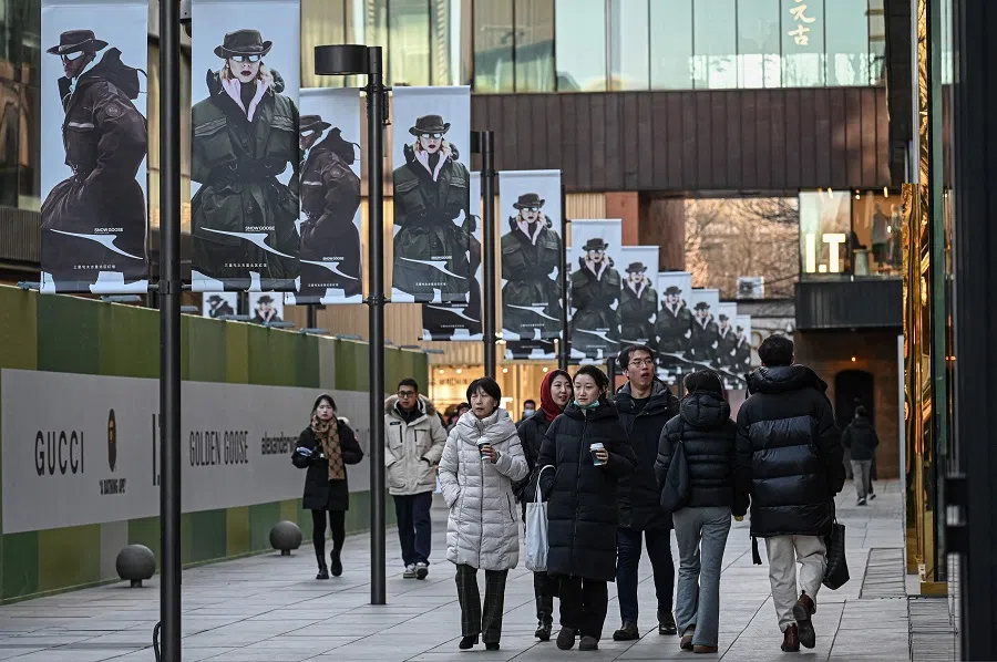 People walk at a shopping mall complex in Beijing, China on 28 December 2024. (Jade Gao/AFP)