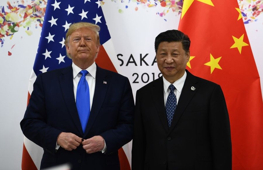 In this file photo taken on 29 June 2019, Chinese President Xi Jinping (R) and US President Donald Trump attend their bilateral meeting on the sidelines of the G20 Summit in Osaka. (Brendan Smialowski/AFP)