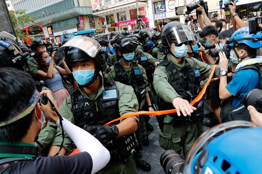 Riot police disperse pro-democracy protesters during a demonstration opposing postponed elections, in Hong Kong, 6 September 2020. (Tyrone Siu/File Photo/Reuters)