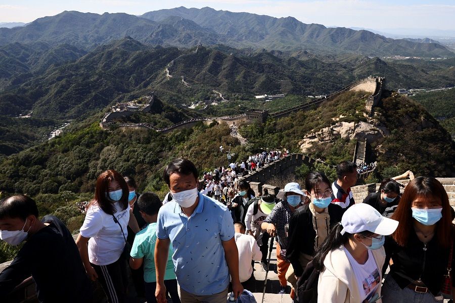 People climb the Great Wall on National Day holiday in Beijing, China, 1 October 2021. (Thomas Peter/Reuters)
