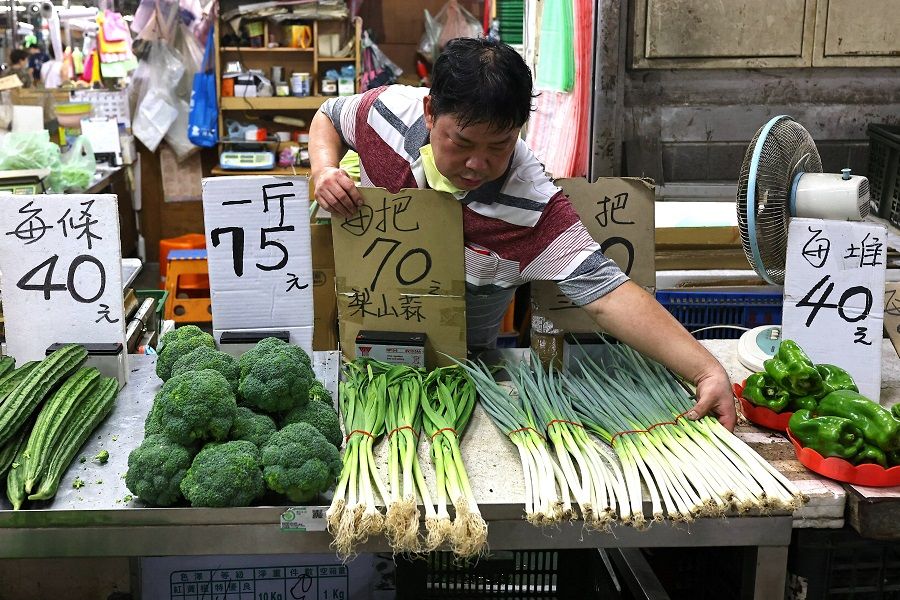 A vegetable seller readies for business at his stall in Taipei, Taiwan, 4 August 2022. (Ann Wang/Reuters)