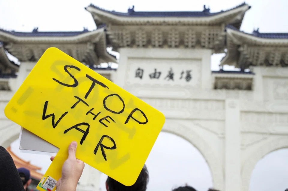 A Slavic people living in Taiwan holds a placard during a protest against Russia's military invasion of Ukraine at the Liberty Square outside the Chiang Kai-shek Memorial Hall in Taipei, Taiwan, on 6 March 2022. (Sam Yeh/AFP)