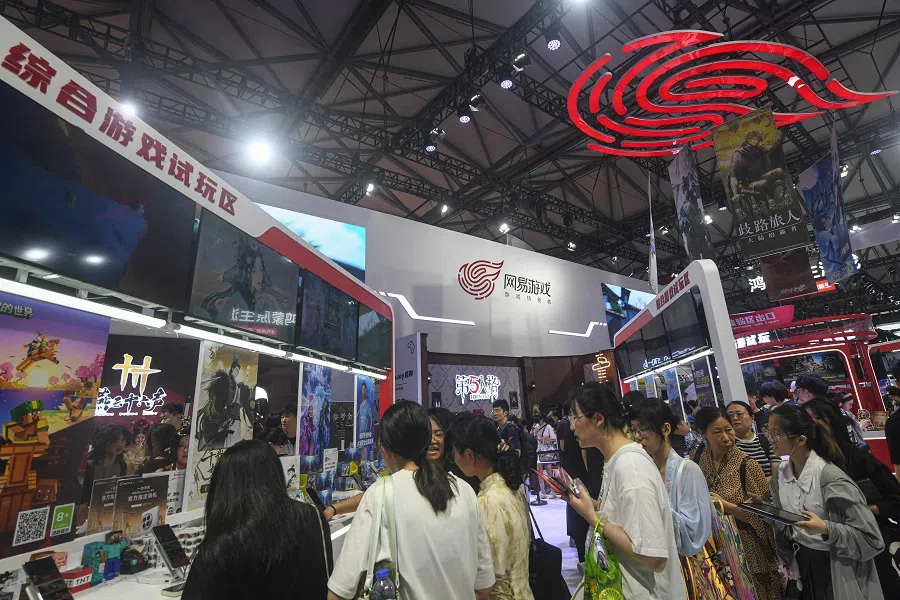 People visit a booth of Chinese gaming company NetEase Games during the annual China Digital Entertainment Expo and Conference, also known as ChinaJoy, in Shanghai, China, on 26 July 2024. (AFP)
