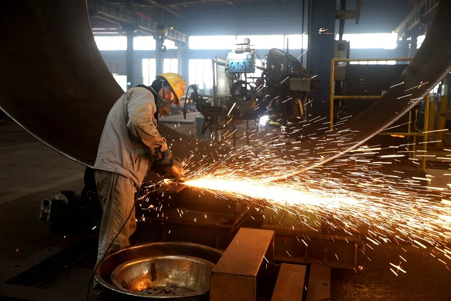 A worker makes a wind turbine component at a factory in Lianyungang, Jiangsu province, China, on 18 September 2025. (AFP)