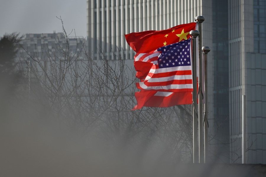 In this file photo taken on 19 January 2020, Chinese and US national flags flutter at the entrance of a company office building in Beijing. (Wang Zhao/AFP)
