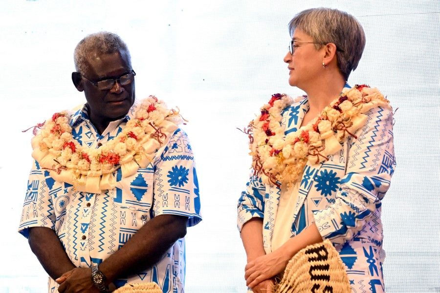 Australia's Foreign Minister Penny Wong (right) and Solomon Islands Prime Minister Manasseh Sogavare (left) chat during traditional welcoming ceremonies at the Pacific Islands Forum (PIF) in Suva on 12 July 2022. (William West/AFP)