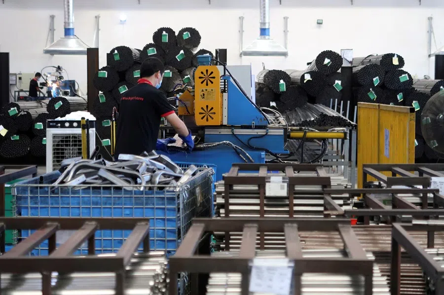 Employees work on the production line of an American infant product and toy manufacturer company at a factory in Jiujiang, Jiangxi province, China, on 22 June 2021.  (Gabriel Crossley/Reuters)