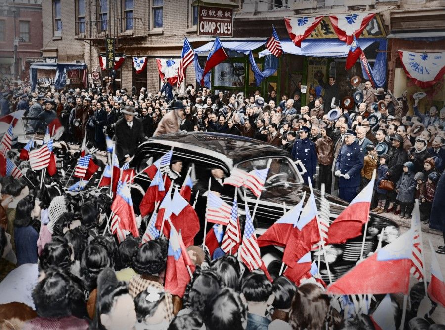 1 March 1943, New York - On her way from Penn Station to City Hall, Madame Chiang and her motorcade pass through Chinatown, as thousands of Chinese stand by waiving American and Chinese flags. Some Chinese restaurants put up banners and decorations to greet her presence. New York Police maintained tight security measures, and two policemen followed right behind her vehicle. Her nephew L.K. Kung is seated in the back row.