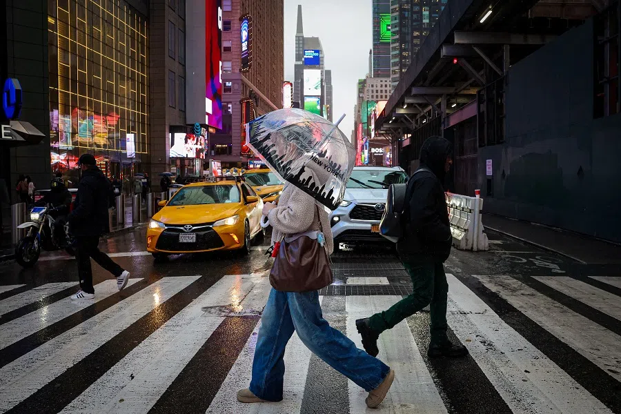 People walk through Times Square during a winter storm in New York City, US, on 6 February 2025. (Brendan McDermid/Reuters)