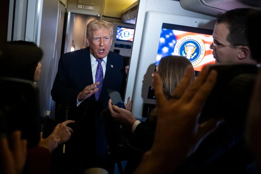 US President Donald Trump speaks to the press aboard Air Force One en-route to Washington, DC, on 30 November 2025. (Pete Marovich/AFP)