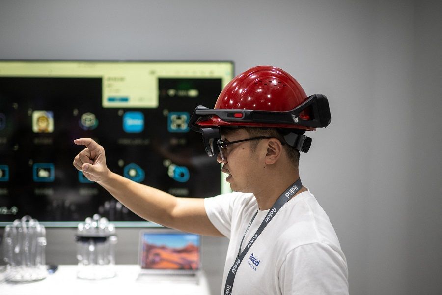 China is placing greater emphasis on S&T and R&D. This picture taken on 22 September 2023 shows an employee from Chinese AR startup Rokid demonstrating an AR helmet at the company's office at the 2022 Asian Games host city Hangzhou, in China's eastern Zhejiang province. (AFP)