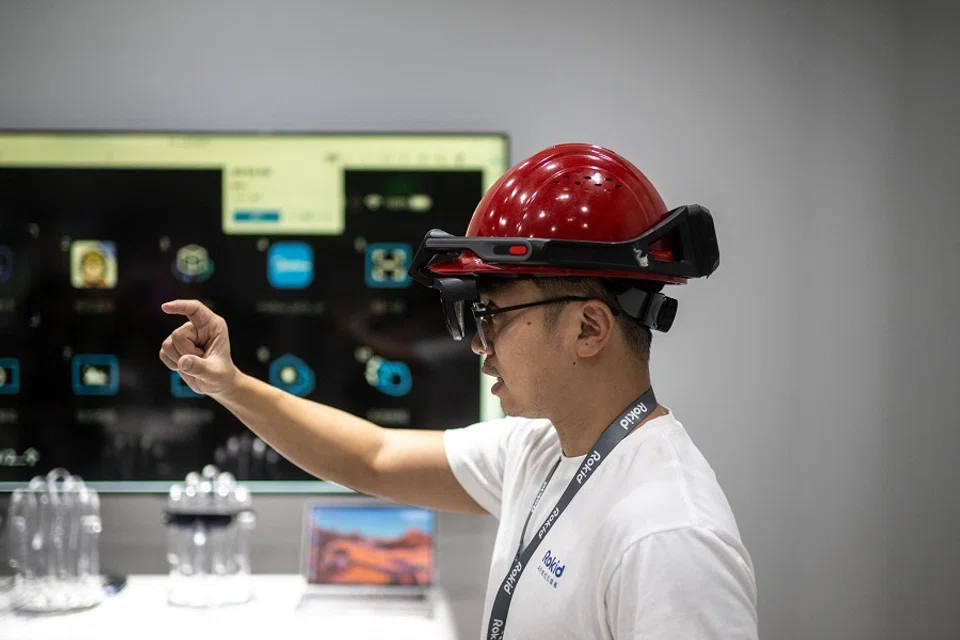 China is placing greater emphasis on S&T and R&D. This picture taken on 22 September 2023 shows an employee from Chinese AR startup Rokid demonstrating an AR helmet at the company's office at the 2022 Asian Games host city Hangzhou, in China's eastern Zhejiang province. (AFP)