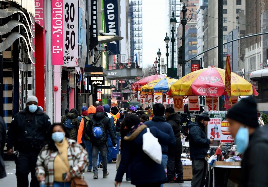 People walk through a busy shopping area amid the coronavirus pandemic on 5 January 2021 in New York City. (Angela Weiss/AFP)