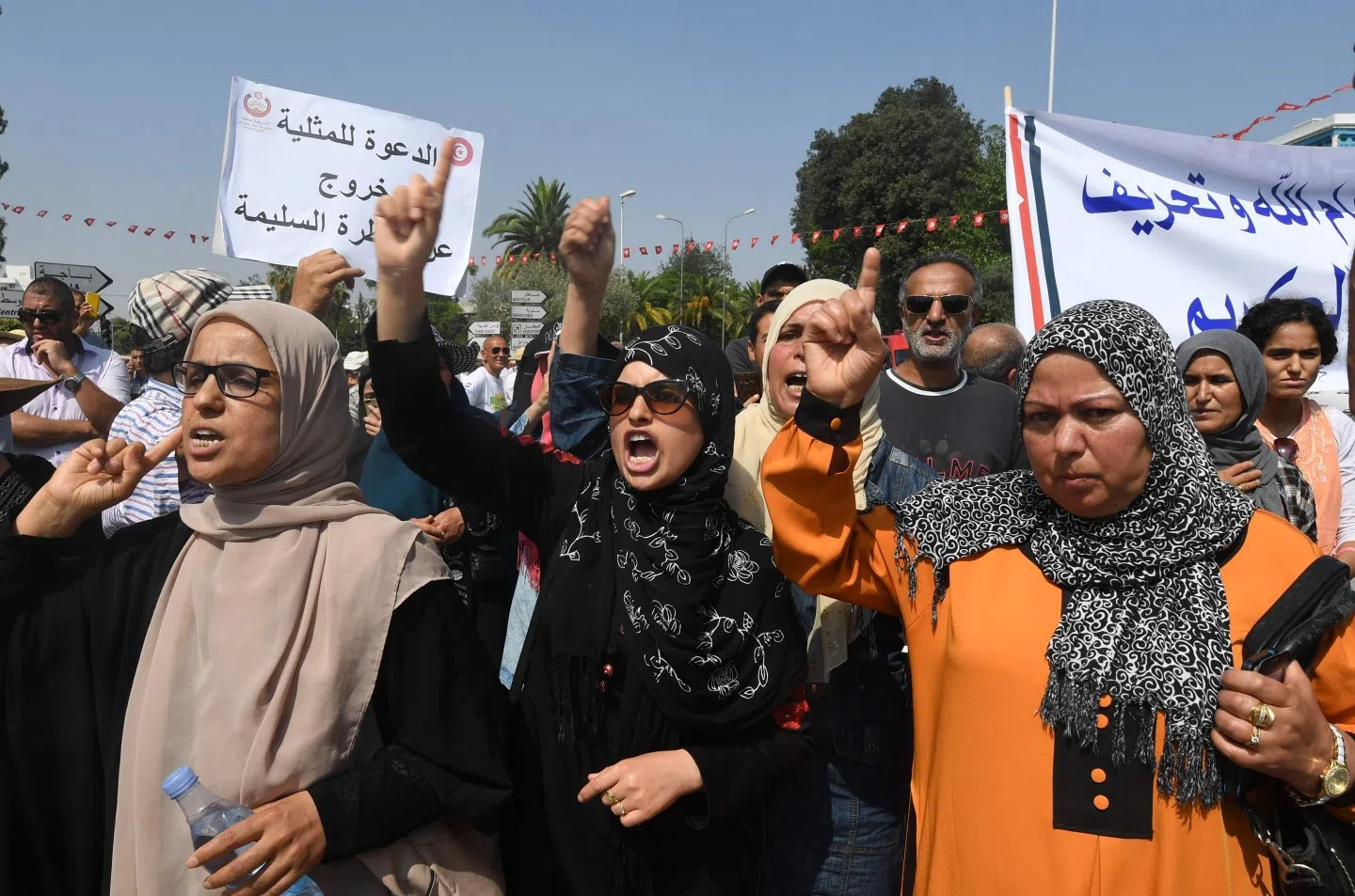 A commission set up by Tunisian President Beji Caid Essebsi to bring the legal code in line with the 2014 constitution adopted after the Arab Spring uprising, unveiled in June a raft of proposed liberal reforms. The photo shows hundreds of Tunisians holding pro-conservative signs during a protest against proposed reforms opposed by conservative Muslims that include equal inheritance rights for women and decriminalising homosexuality, on 11 August 2018 in Tunis. (Photo by Fethi Belaid/AFP)